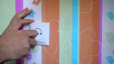 Installation of an electrical socket in children room Stock Footage 164558402