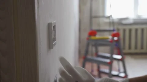 Installation of an electrical switch on the wall during the renovation of the Stock Footage 278257935
