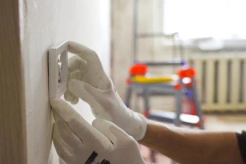 Installation of an electrical switch on the wall during the renovation of t.. Stock Photos