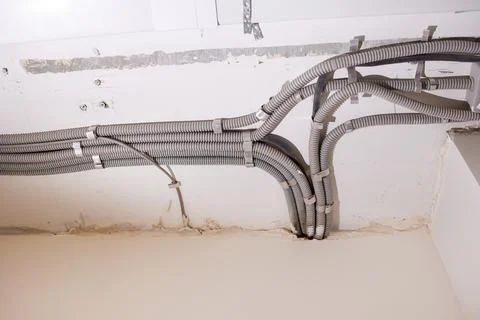 Installation of electrical wiring on the ceiling. Stock Photos