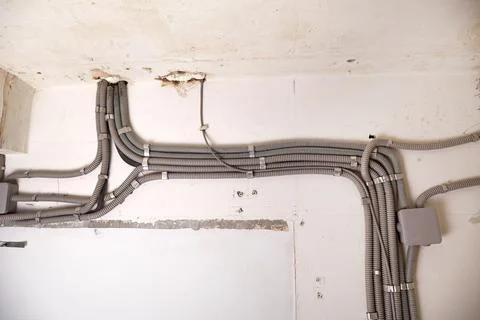 Installation of electrical wiring on the ceiling. 스톡 사진