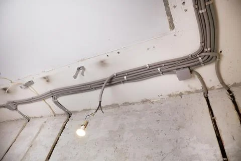 Installation of electrical wiring on the ceiling. Stock Photos
