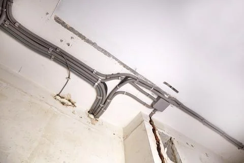 Installation of electrical wiring on the ceiling. Stock Photos