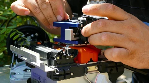 Installation of fiber optic cable in the welding machine 스톡 동영상 123586741