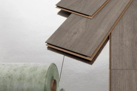 Installation of floating floor, underlay with sheets of laminate. Home improv Stock Photos