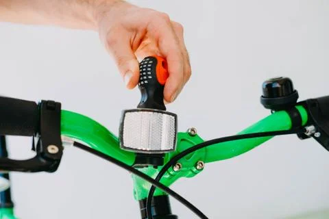 Installation of a front reflective green fix bike with white tires Stock Photos