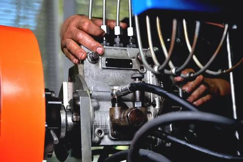 Installation of a fuel pump for a diesel engine after repair on an adjustment Stock Photos
