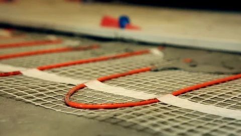 Installation of heated floor. Laying a ceramic or porcelain tile floor close- Video stock 109184567