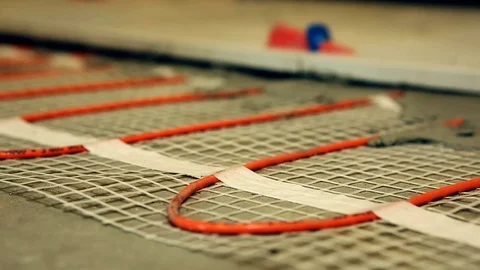 Installation of heated floor. Laying a ceramic or porcelain tile floor close- Video stock 109184577