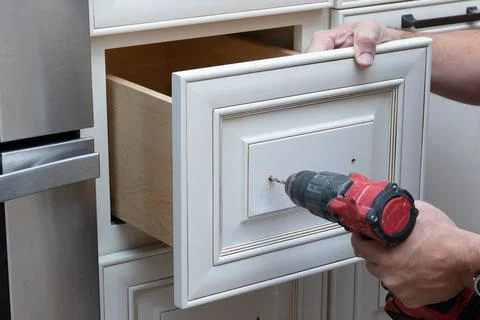 Installation of kitchen cabinet handles Stock Photos