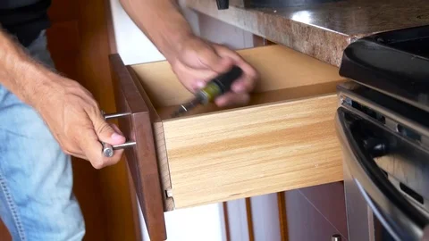 Installation of kitchen Workman fixes the drawer in cabinet Stock Footage 71836720