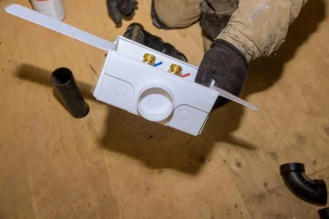 Installation of a laundry outlet boxes in a new house for connection of water Stock Photos