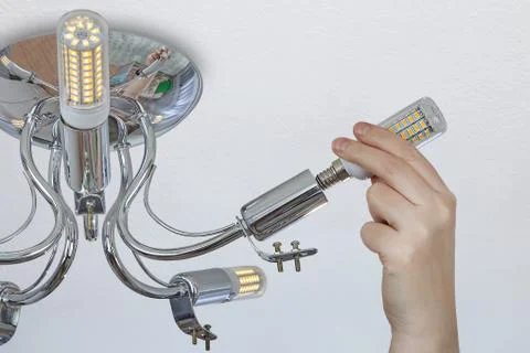 Installation of LED corn lights in a ceiling chandelier. Stock Photos