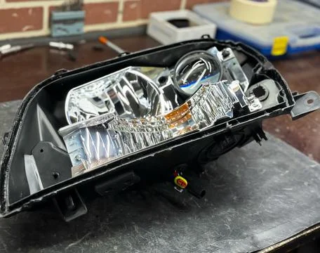 Installation of LED lenses in the headlight. Stock Photos