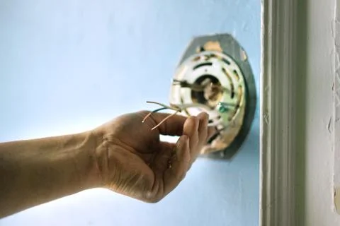 Installation of the light plate in a rough wall. Stock Photos