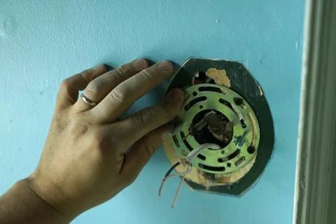 Installation of the light plate in a rough wall. Stock Photos