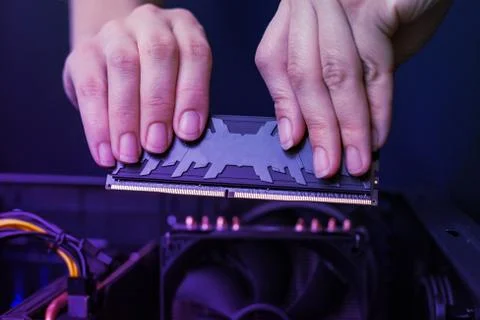 Installation of modern DDR memory module with heat sink. High performance mem Stock Photos