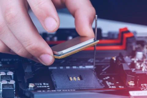 Installation of modern processor in CPU socket on the motherboard 스톡 사진