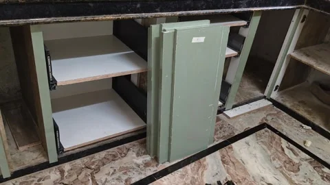 Installation of Modern Sage Green Modular Kitchen Cabinets in a Home Stock Footage 325039476
