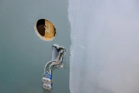 Installation of a new current socket by an electrician working in a construction Stock Photos