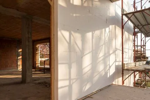 Installation of outer coat insulating on a residential home Stock Photos