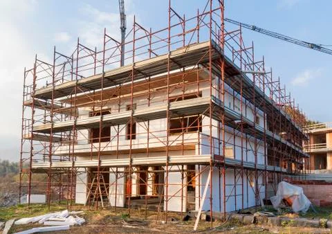 Installation of outer coat insulating on a residential home Stock Photos