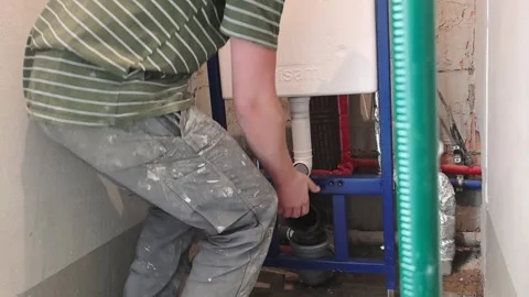 Installation of plumbing system in bathroom with a focus on pipes, fittings, and Video stock 329700627