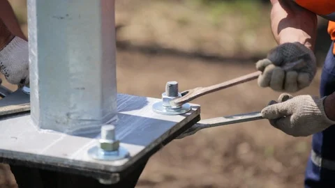 Installation of power lines. Workers tighten the nuts  Stock Footage 106489450