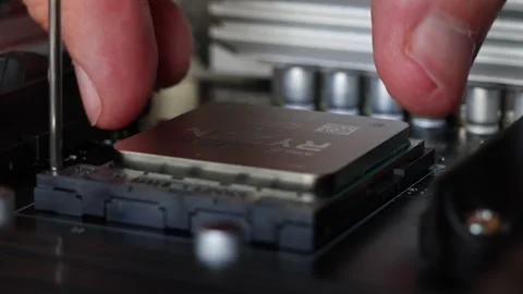 Installation process of CPU AMD Ryzen processor in AM4 socket on motherboard. Stock Footage 312159998