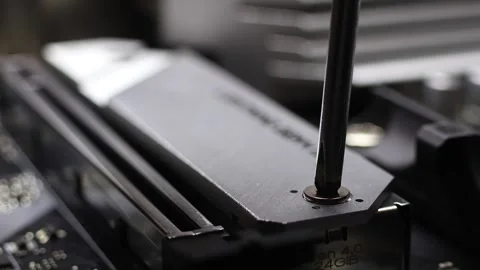 Installation process of NVME SSD drive in M.2 2280 slot on B550 motherboard. Stock Footage 312160365