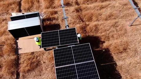Installation process of solar panel banks with machinery Stock Photos