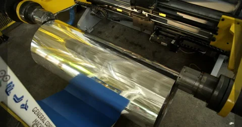The installation of the roll of aluminum foil in its place in the machine Stock Footage 89909549