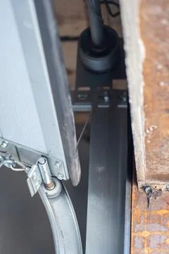 Installation of the rollers for the automatic garage door Stock Photos
