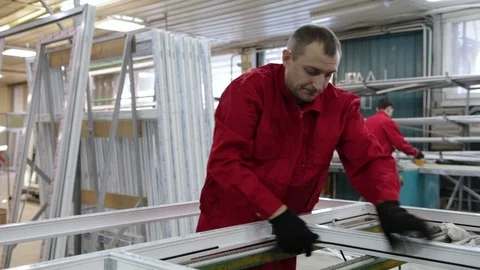 Installation of rubber sealant in plastic windows and doors. Manual worker assem Stock Footage 100876512