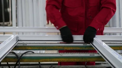 Installation of rubber sealant in plastic windows and doors. Manual worker assem Stock Footage 100876574