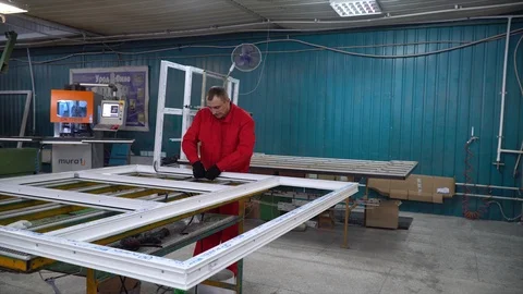 Installation of rubber sealant in plastic windows and doors. Manual worker assem Stock Footage 100880701