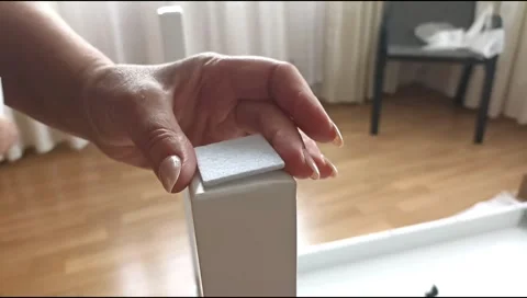 Installation of a self adhesive felt pad on a furniture leg to protect flooring 스톡 동영상 339177274