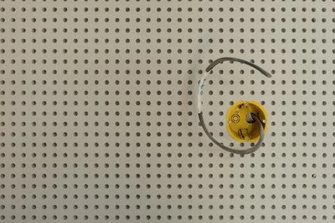 Installation of a socket with wiring a wall made of perforated plasterboard Stock Photos