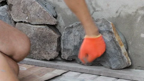 Installation of a stone on the facade of the house Stock Footage 104567714