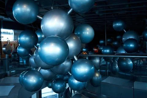 Installation of stylish connected silver balls decoration modern interior in  Stock Photos