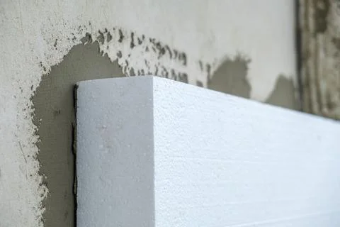 Installation of styrofoam insulation sheets on house facade wall for thermal  Stock Photos
