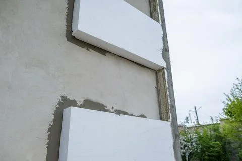 Installation of styrofoam insulation sheets on house facade wall for thermal  Stock Photos