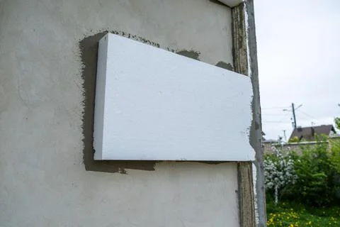 Installation of styrofoam insulation sheets on house facade wall for thermal Stock Photos