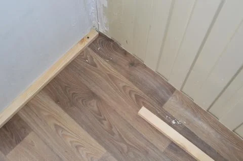 Installation of thresholds and baseboards in the interior of a residential bu Stock Photos