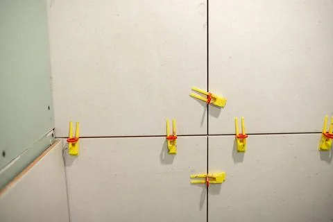 Installation of Tile Leveling Clips on a Construction Wall in a Home Renovation Stock Photos