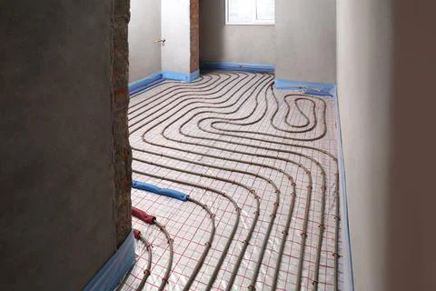 Installation of underfloor heating system in building Fotos de archivo