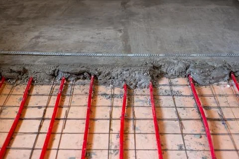Installation of underfloor heating. Underfloor heating pipes are attached t.. Stock Photos