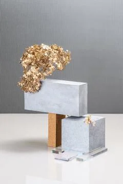 Installation using concrete blocks, textural building elements and a golden p Stock Photos