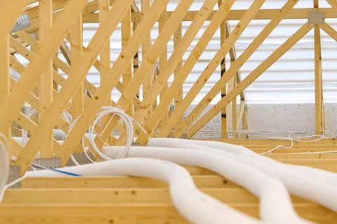 Installation of ventilation in a new timber frame house under construction Stock Photos