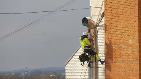 Installation of a ventilation pipe, High altitude worker ; Specially equipped Stock Footage 154167040